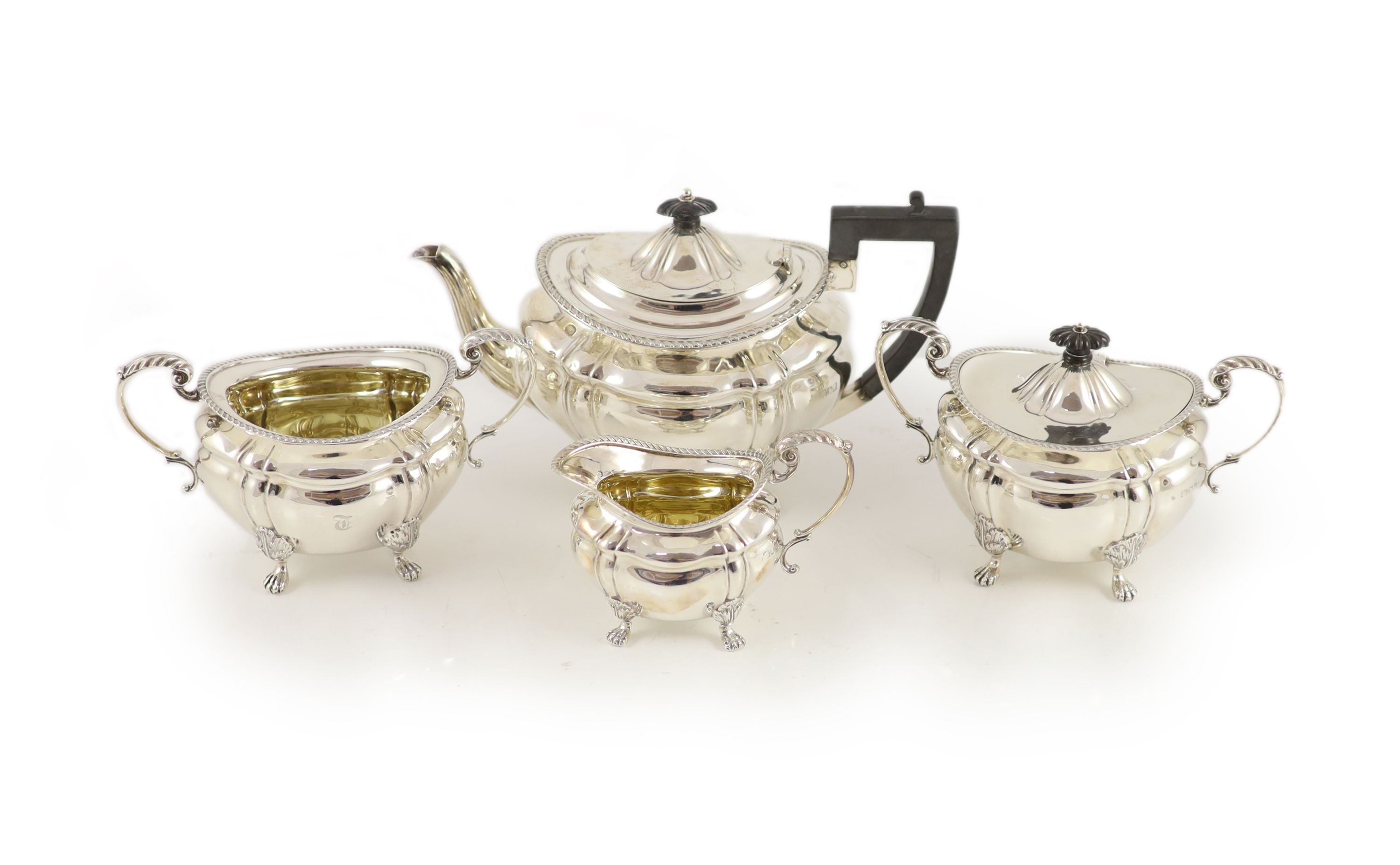A late Victorian four-piece silver tea set comprising teapot, lidded bowl, twin handed sugar basin and jug with gilded bowls throughout, Josiah Williams & Co, London, 1900